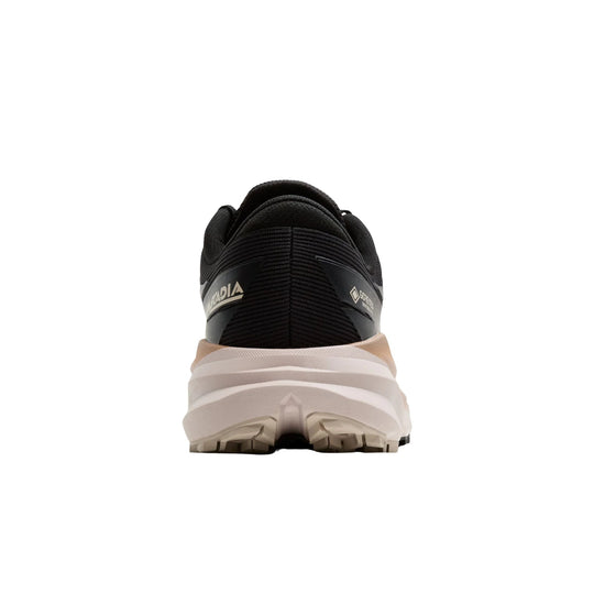 Rear view of a black trail running shoe with a beige lugged sole and visible GORE-TEX branding