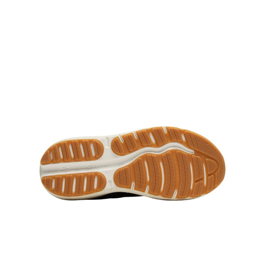 Shoe outsole with orange rubber traction pods and white midsole, showing Brooks branding