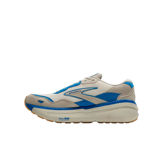 Cream, blue, and tan Brooks running shoe in side view with thick cushioned sole.