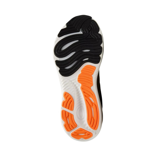 Running shoe outsole with black tread and orange traction pods on a white midsole