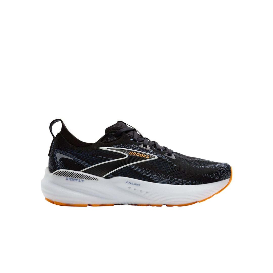 Black running shoe with white midsole, orange outsole accents, and visible side branding