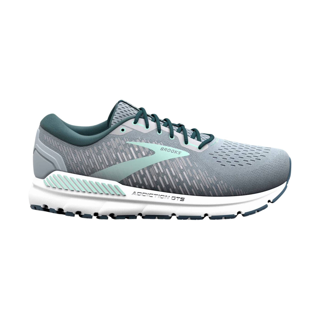 Gray running shoe with teal laces, logo, and cushioned white sole