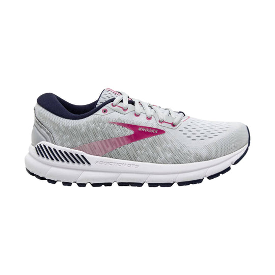 White and gray running shoe with pink accents, navy interior, and Brooks branding