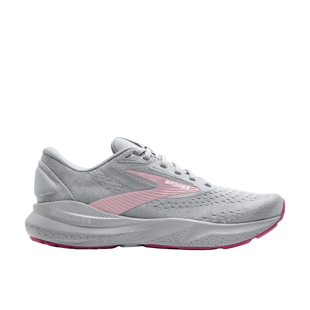 Light gray running shoe with pink side logo, pink outsole accents, and visible Brooks and Adrenaline GTS markings