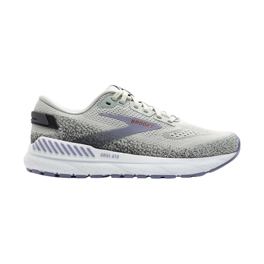 Light gray and lavender Brooks running shoe in side view with white laces and cushioned sole