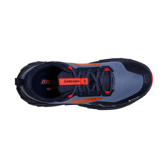 Navy trail running shoe with orange accents, mesh upper, and visible Cascadia and GORE-TEX markings