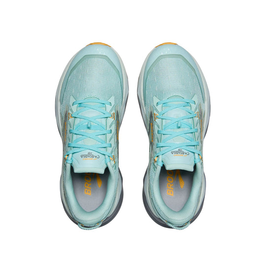 Light blue trail running shoes with aqua laces and orange Brooks branding, shown top-down on a white background