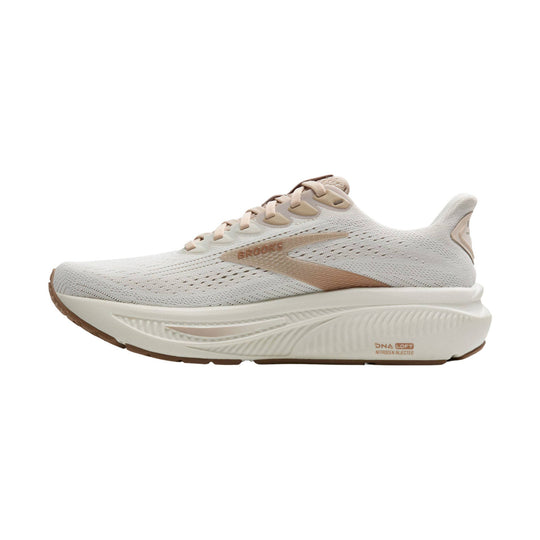 Cream and beige running shoe with mesh upper, thick cushioned sole, and brown outsole accents
