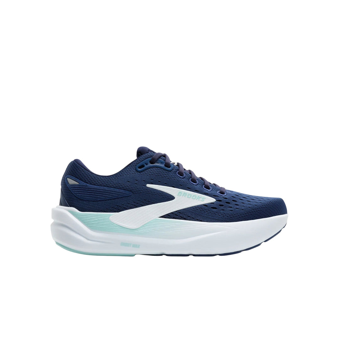 Navy blue running shoe with white midsole and light teal accents, side view