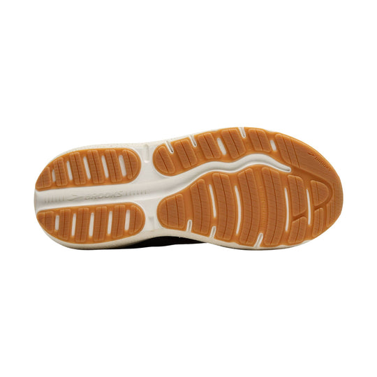 Walking shoe outsole with orange traction pods and white foam midsole, featuring Brooks branding