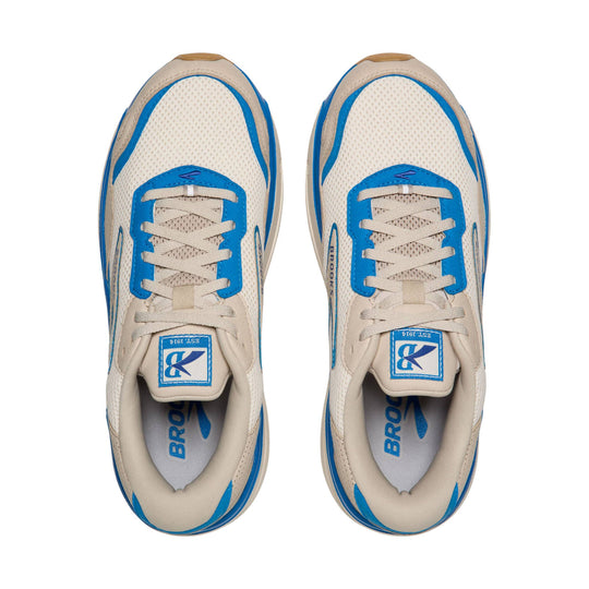 Pair of cream mesh walking shoes with blue trim, shown from above, with laces and Brooks branding