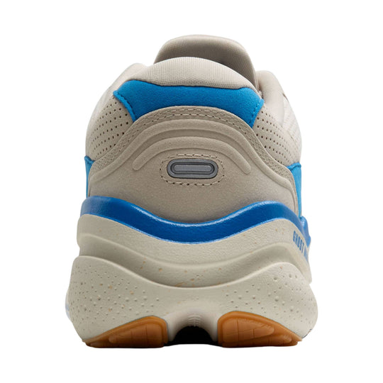 Cream and blue walking shoe seen from the back with a thick cushioned sole and orange tread accents