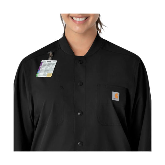 Black button-front scrub coat with chest pockets and a clipped ID badge