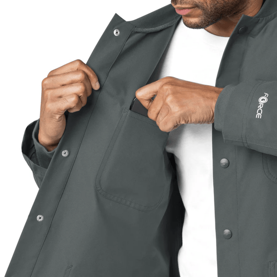 Dark gray snap-front scrub coat with chest pocket and visible FORCE logo on the sleeve