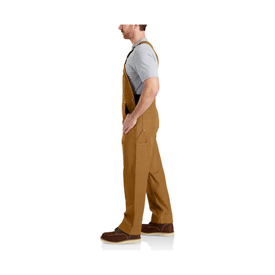 Man wearing tan bib overalls over a gray T-shirt, shown in side view