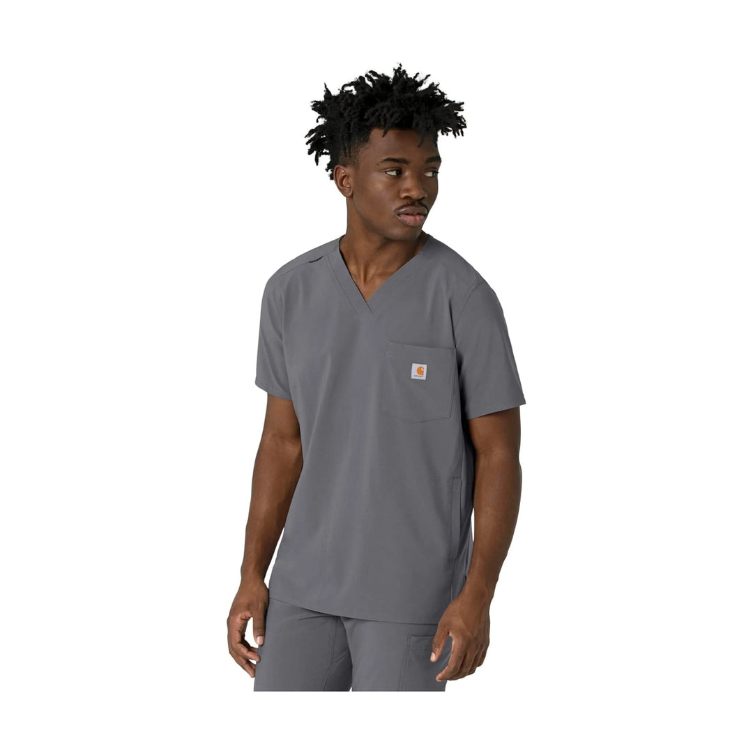 Gray V-neck scrub top with chest pocket and small logo patch, shown on a model