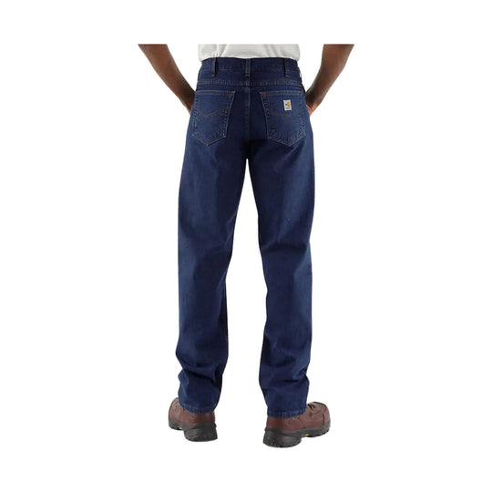 Dark blue relaxed-fit jeans shown from the back with five pockets and brown work boots