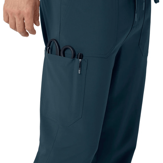 Navy scrub pants with a cargo pocket holding scissors and a pen