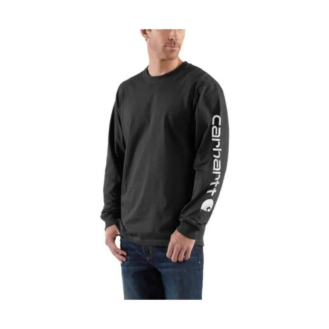 Man wearing a black long-sleeve shirt with a Carhartt logo on a white background