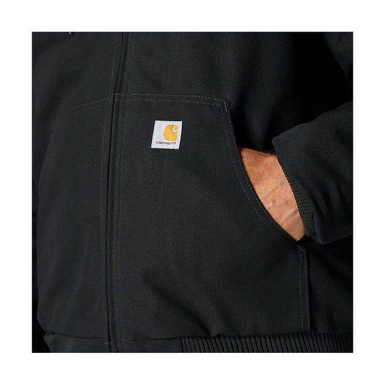 Black canvas jacket pocket with Carhartt logo patch