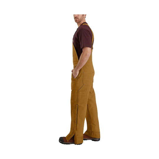 Brown insulated bib overalls on a man, side view, with chest straps and utility pockets
