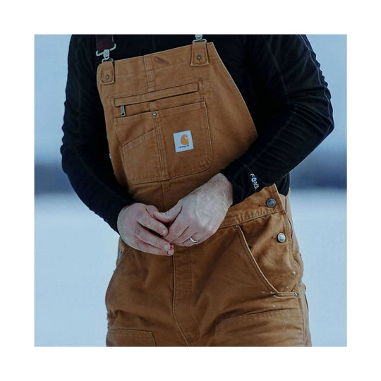 Brown insulated bib overalls with chest pocket and black long-sleeve shirt