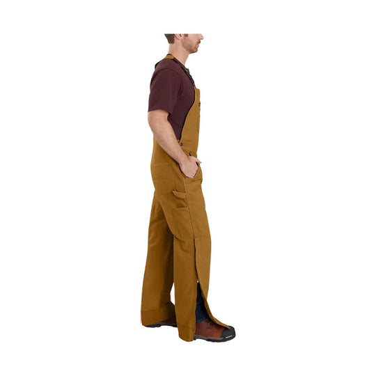 Man wearing brown insulated bib overalls with cargo pockets, side zippers, and work boots, shown in side view.