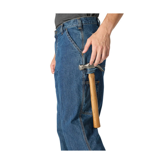 Blue denim work pants with a side tool pocket holding a hammer