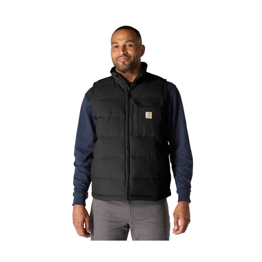 Black insulated vest worn over a navy long-sleeve shirt