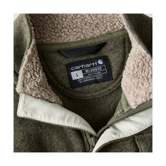 Close-up of an olive fleece jacket interior with sherpa lining and a Carhartt label.