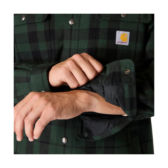 Green and black plaid flannel shirt with snap buttons and a Carhartt chest logo patch