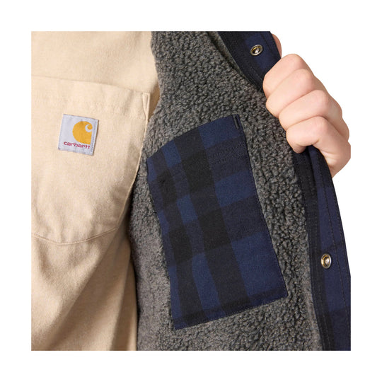 Navy plaid shirt jacket with gray sherpa lining and a Carhartt chest patch