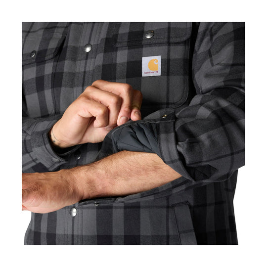 Black and gray plaid flannel shirt jacket with snap buttons, chest pockets, and a Carhartt logo patch
