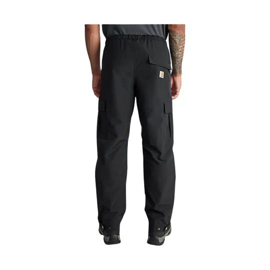 Black relaxed-fit cargo pants with an elastic waistband, flap pocket, and snap hems, rear view