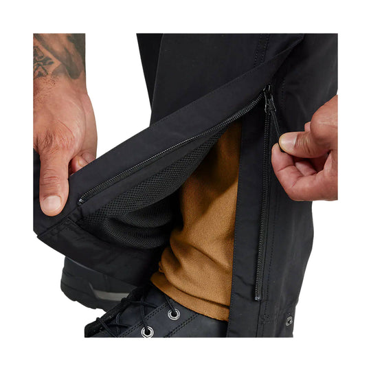 Black pant leg with a zippered side vent open to reveal mesh lining and tan inner fabric