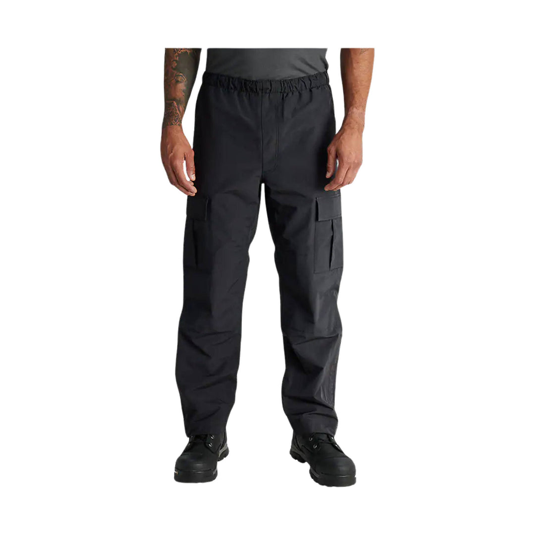 Black relaxed-fit cargo pants with elastic waist, side cargo pockets, and black boots