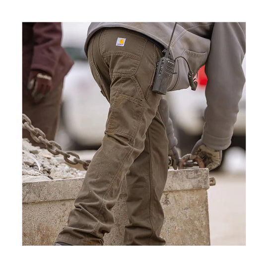 Brown relaxed-fit work pants with utility pockets, shown on a person at a construction site