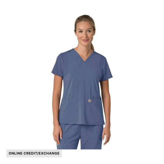 Woman wearing a blue V-neck scrub top and matching pants