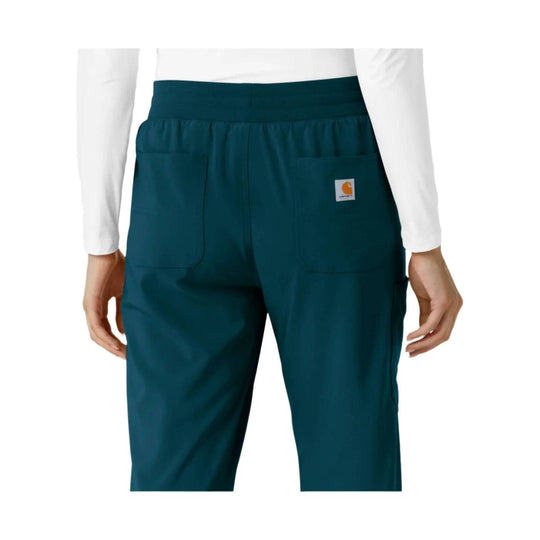 Teal boot-cut scrub pants with wide waistband, two back patch pockets, and small Carhartt logo patch