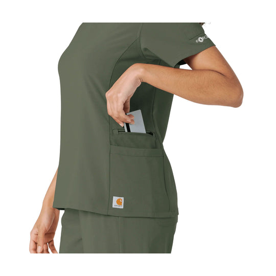 Olive short-sleeve scrub top with side utility pocket, shown in side view with a card in the pocket