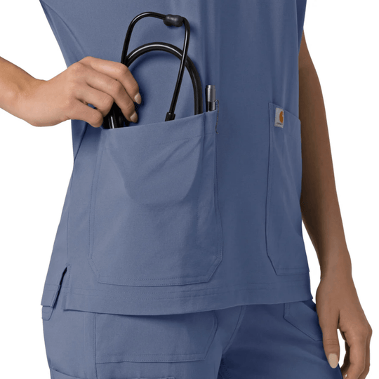 Blue V-neck scrub top with large front pockets and a small Carhartt logo patch
