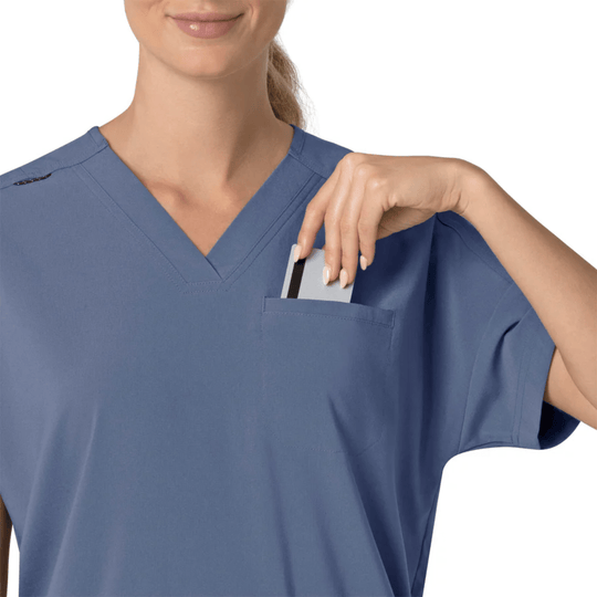 Blue V-neck scrub top with chest pocket and pen