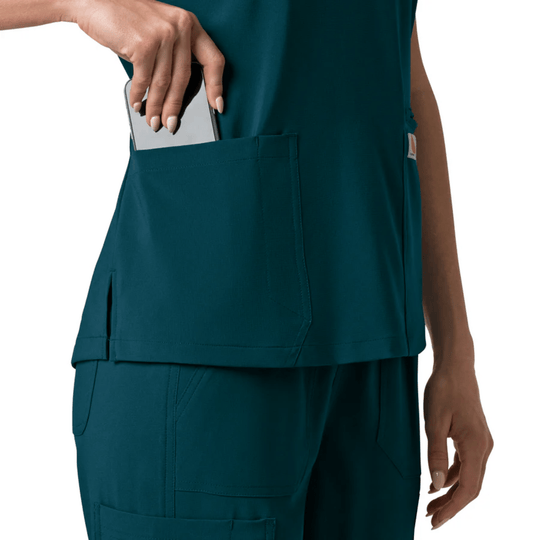 Teal V-neck scrub top with large front pocket, worn with matching scrub pants