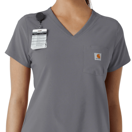 Gray V-neck scrub top with chest pocket, attached ID badge, and small Carhartt logo patch