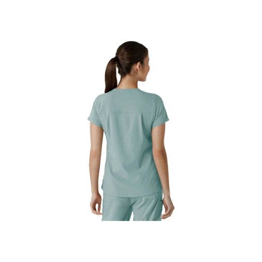 Back view of a light blue short-sleeve scrub top on a model