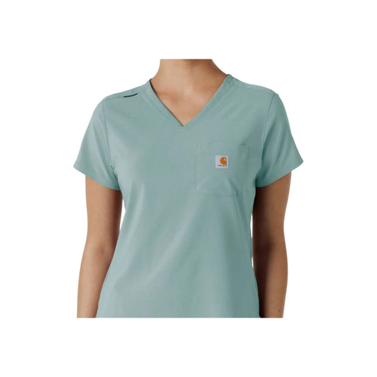 Light blue V-neck scrub top with short sleeves, chest pocket, and small logo patch