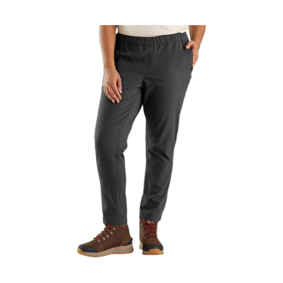Black straight-leg work pants with elastic waistband, side pockets, and brown hiking boots