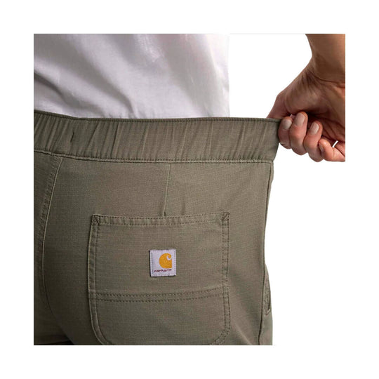 Olive work pant back pocket with Carhartt logo patch and elastic waistband