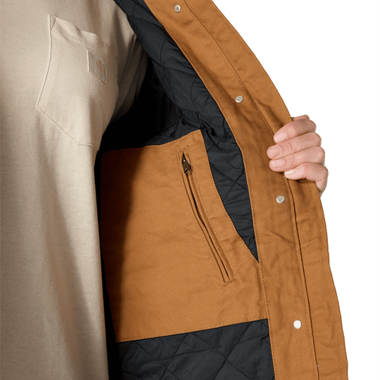 Brown canvas coat with black quilted lining, snap front, and zippered chest pocket shown open.