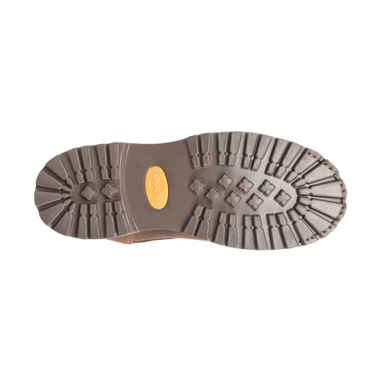 Close-up of a brown boot sole with tread pattern on a white background